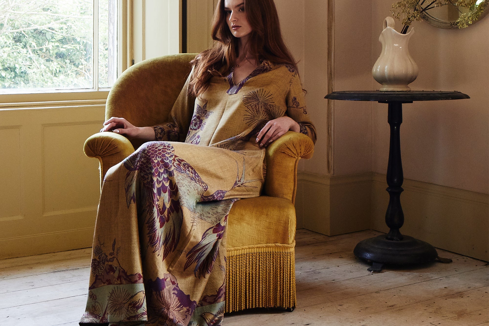 Girl sitting in chair with Luxury Gold Floral Gown on