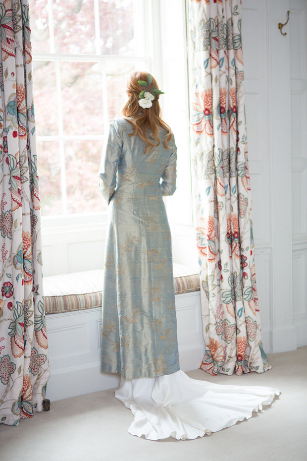 Long light blue silk coat with embroidered flowers. Long silver wedding coat.