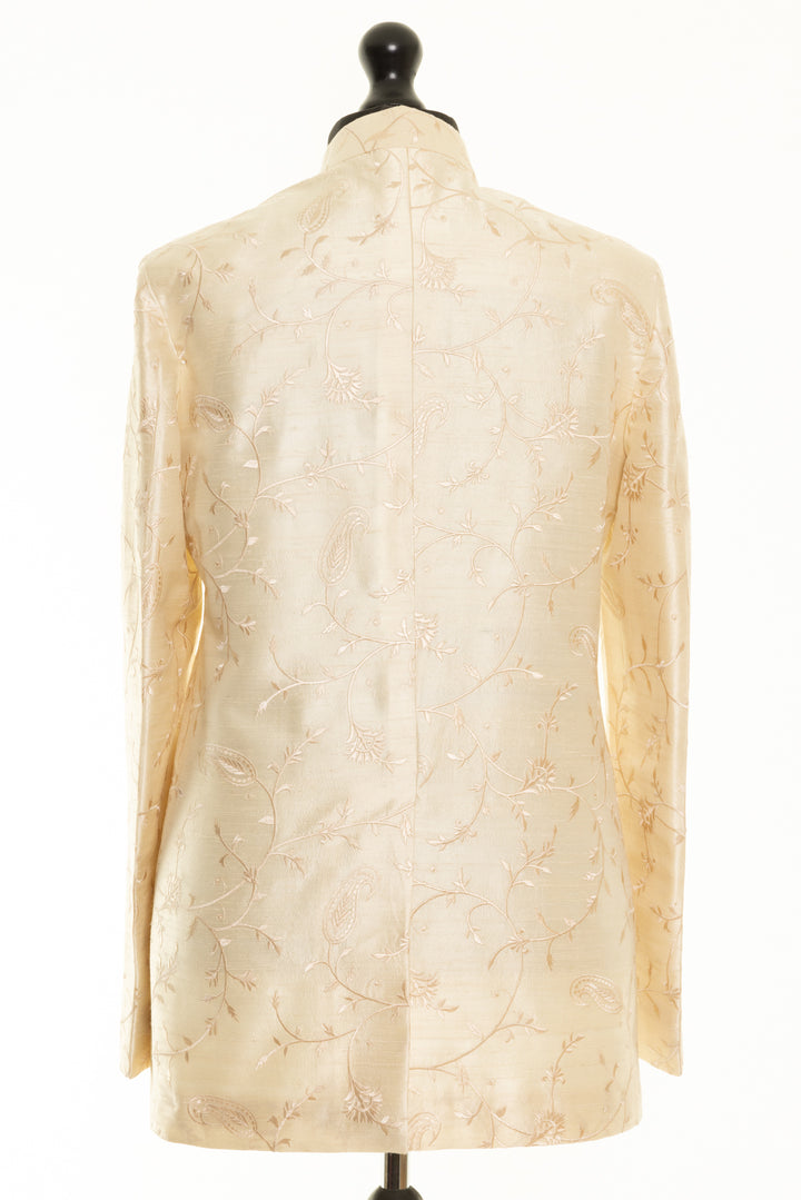 Stylish handmade silk jacket with Nehru collar and detailed embroidery, perfect for grooms. This men's ivory jacket has floral pattern.