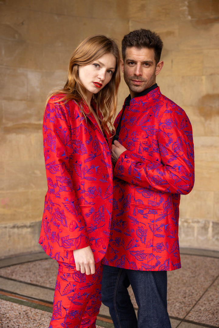 couple wearing matching red silk jackets with embroidered flowers