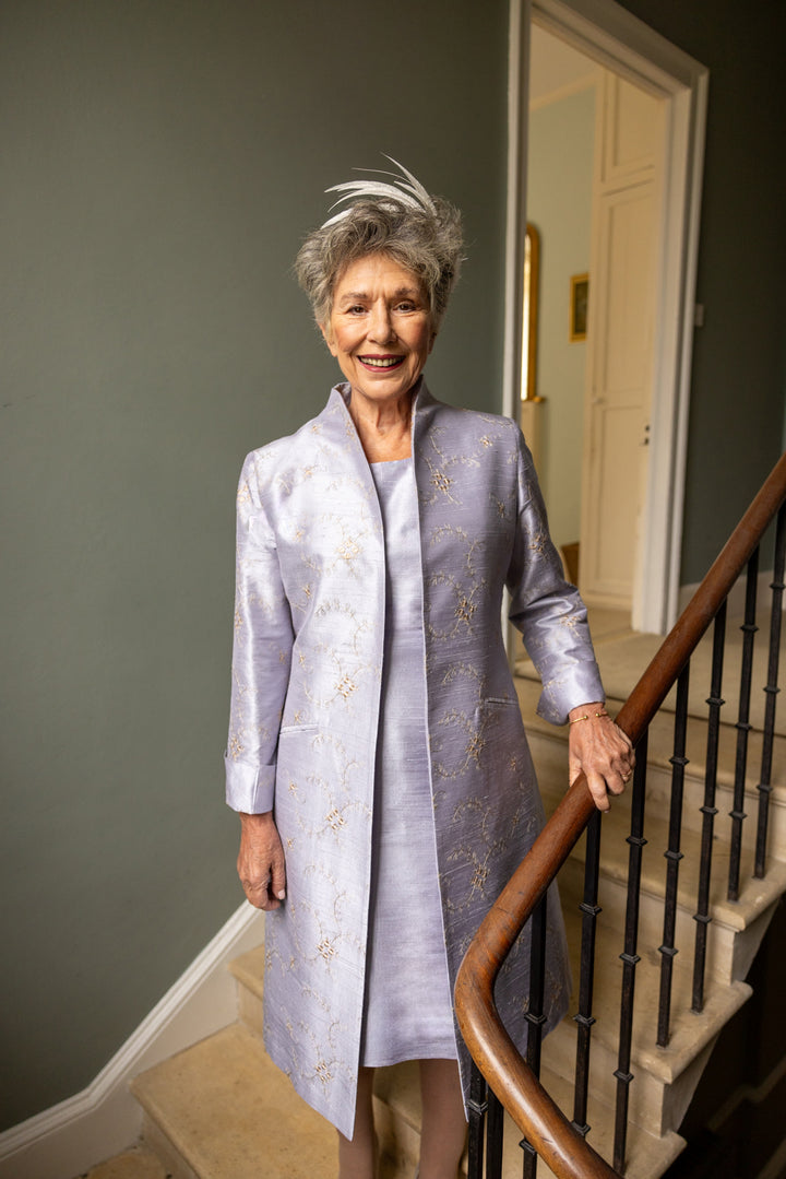 Mother of the bride coat and dress outfit in lilac. Silk mid length coat with embroidery and shift dress in raw silk in lilac.