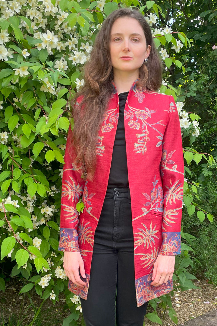 Longline red jacket for women with floral pattern.