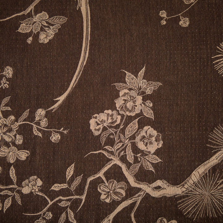 Embroidered design of floral and branch patterns on a dark fabric background