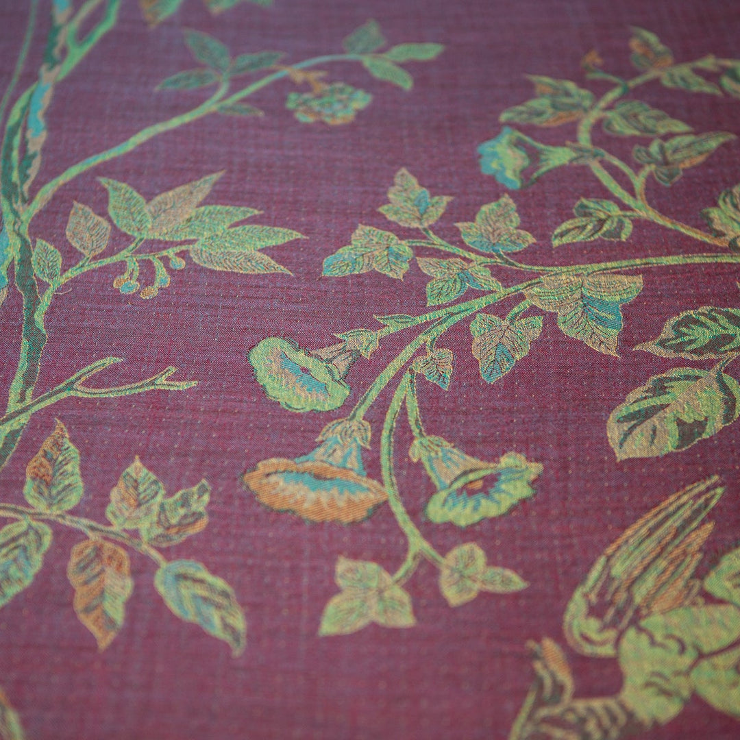 Close-up of fabric with floral pattern on a maroon background