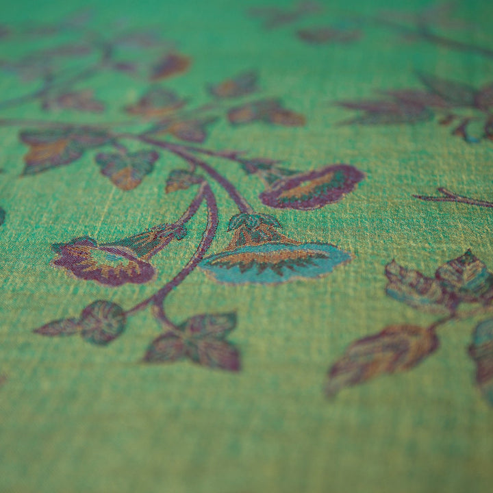 Close-up of a textured fabric with floral patterns on a green background