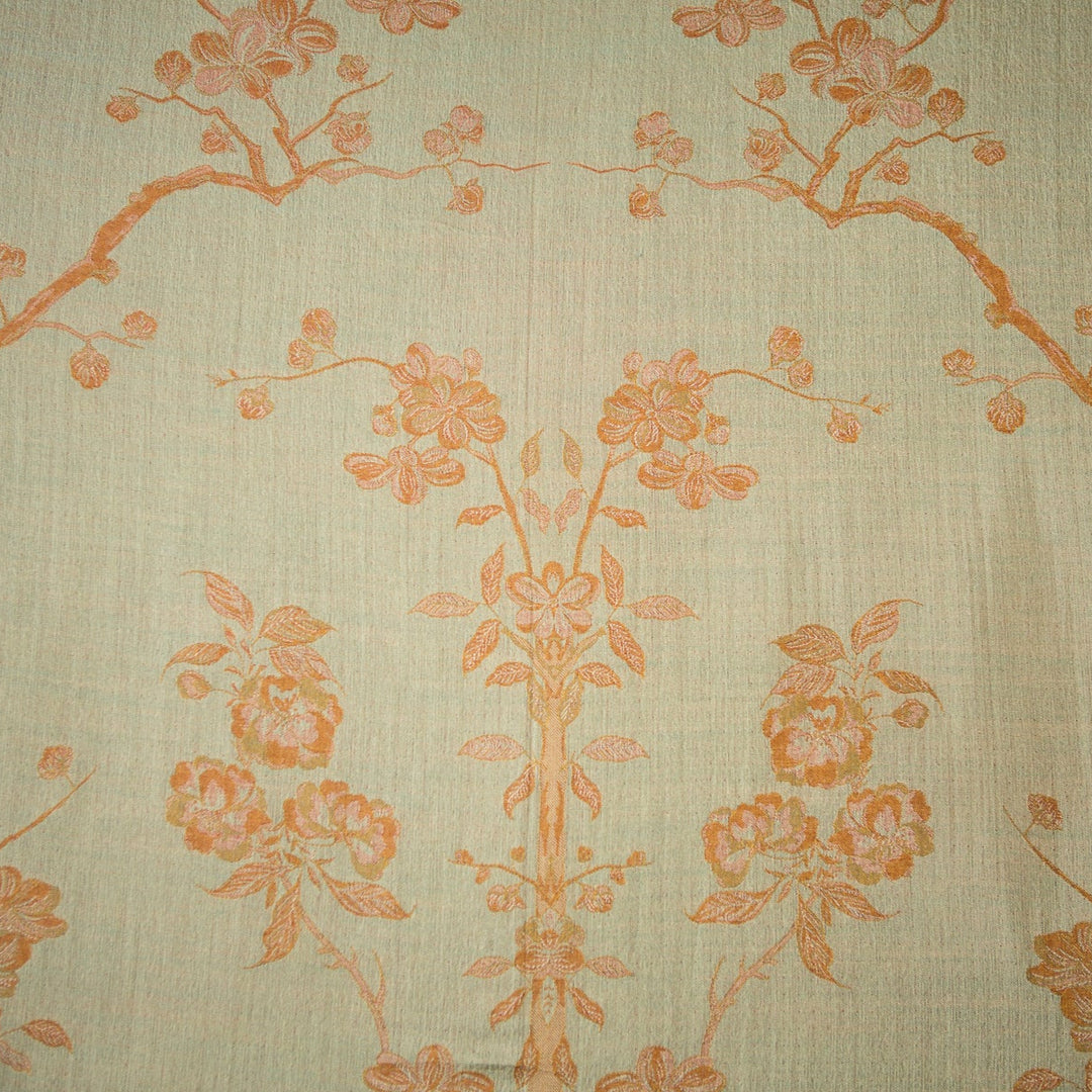 Fabric with floral and bird pattern in orange on a beige background