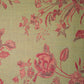 Floral patterned fabric with red flowers on a green background