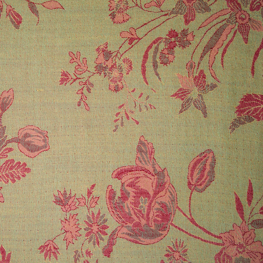 Floral patterned fabric with red flowers on a green background