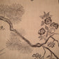 Traditional Chinese ink painting of a branch with flowers and pine needles on a beige background