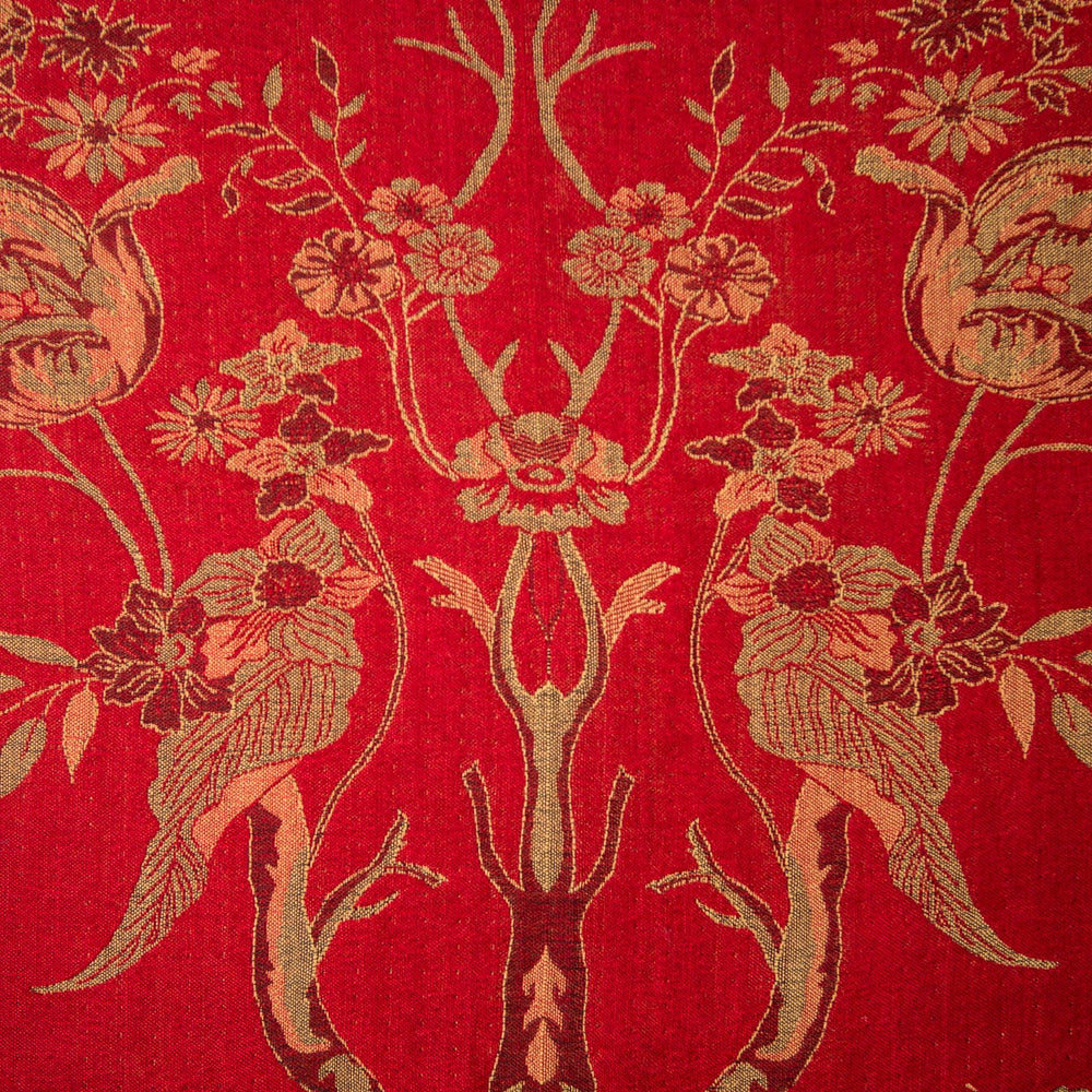 Decorative fabric with floral and leaf patterns on a red background