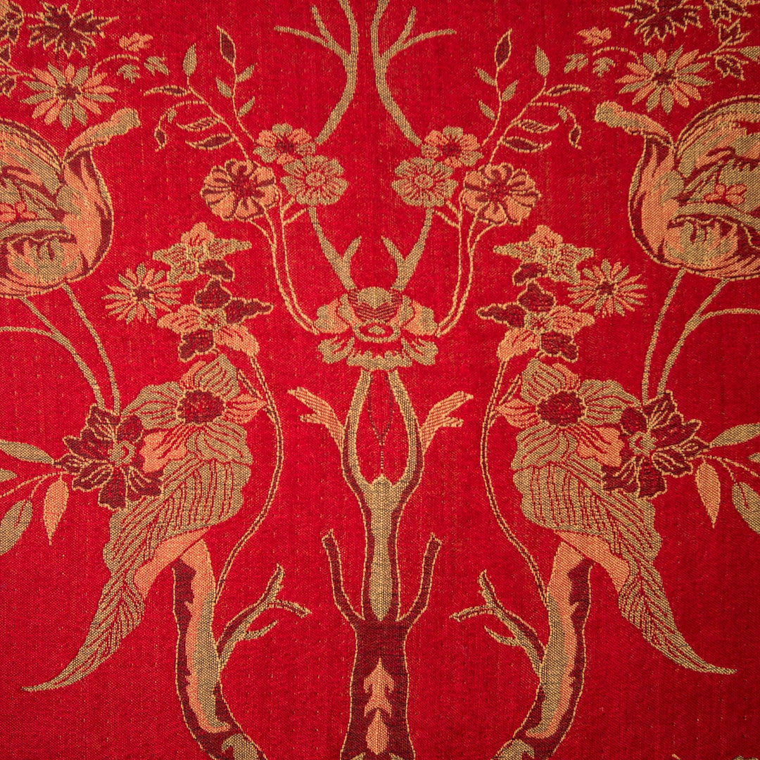 Decorative fabric with floral and leaf patterns on a red background