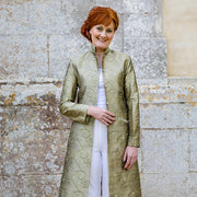 Mother of the bride wearing a green silk jacket. 