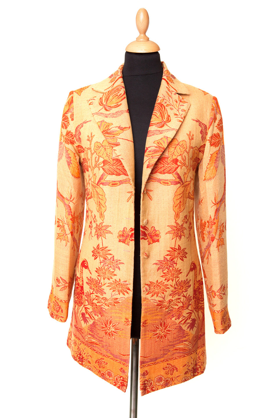 Orange and yellow longline women's jacket with tree of life pattern.