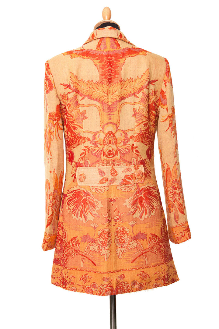 Back of an orange and yellow women's jacket with tree of life pattern.