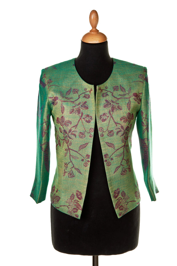Short jacket on mannequin, green colour with red flowers