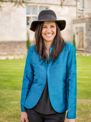Anya Silk Jacket in Kingfisher Blue, woman wearing hat. 