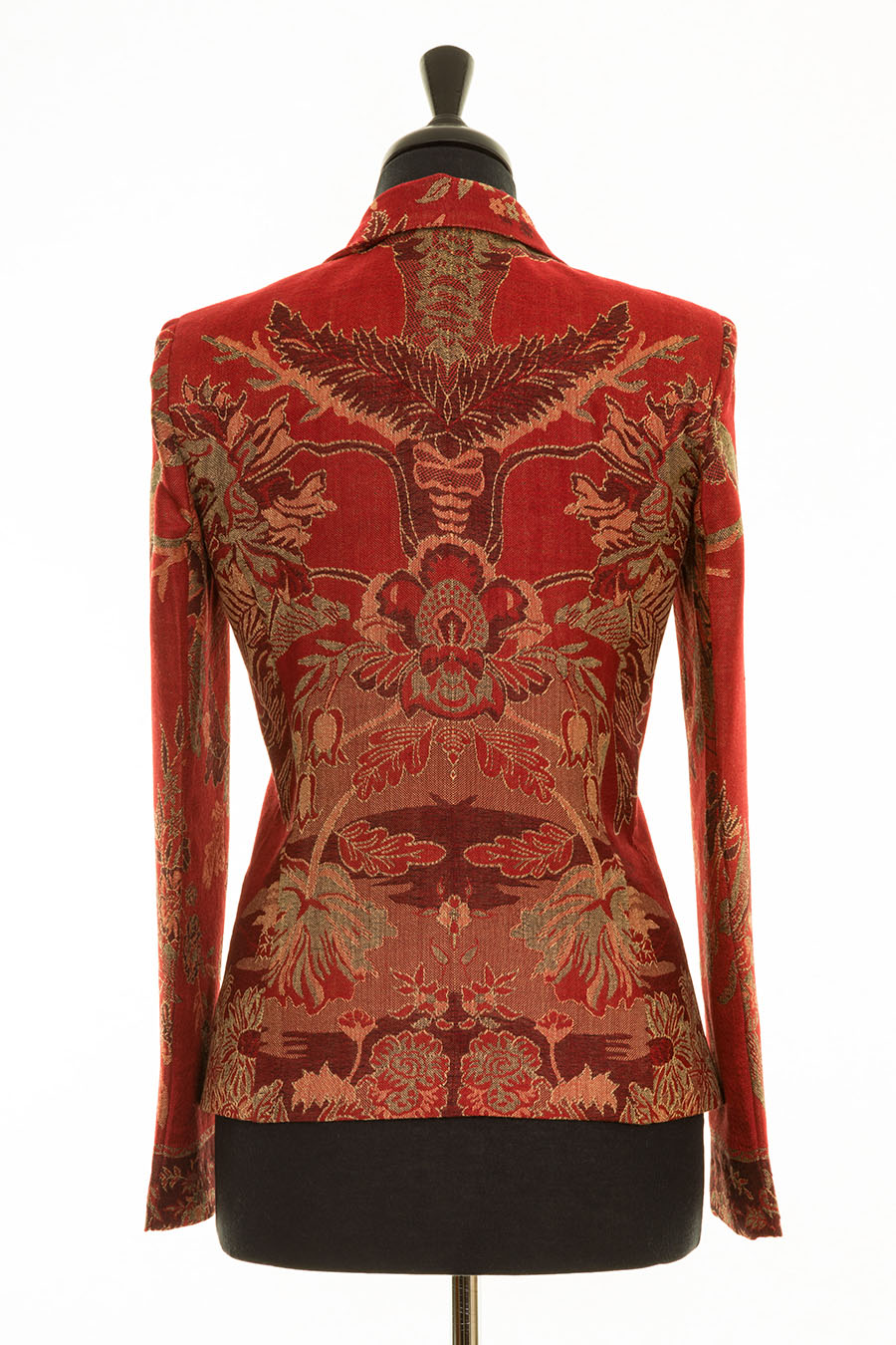 Back of a jacket showing tree of life pattern on red cashmere fabric.