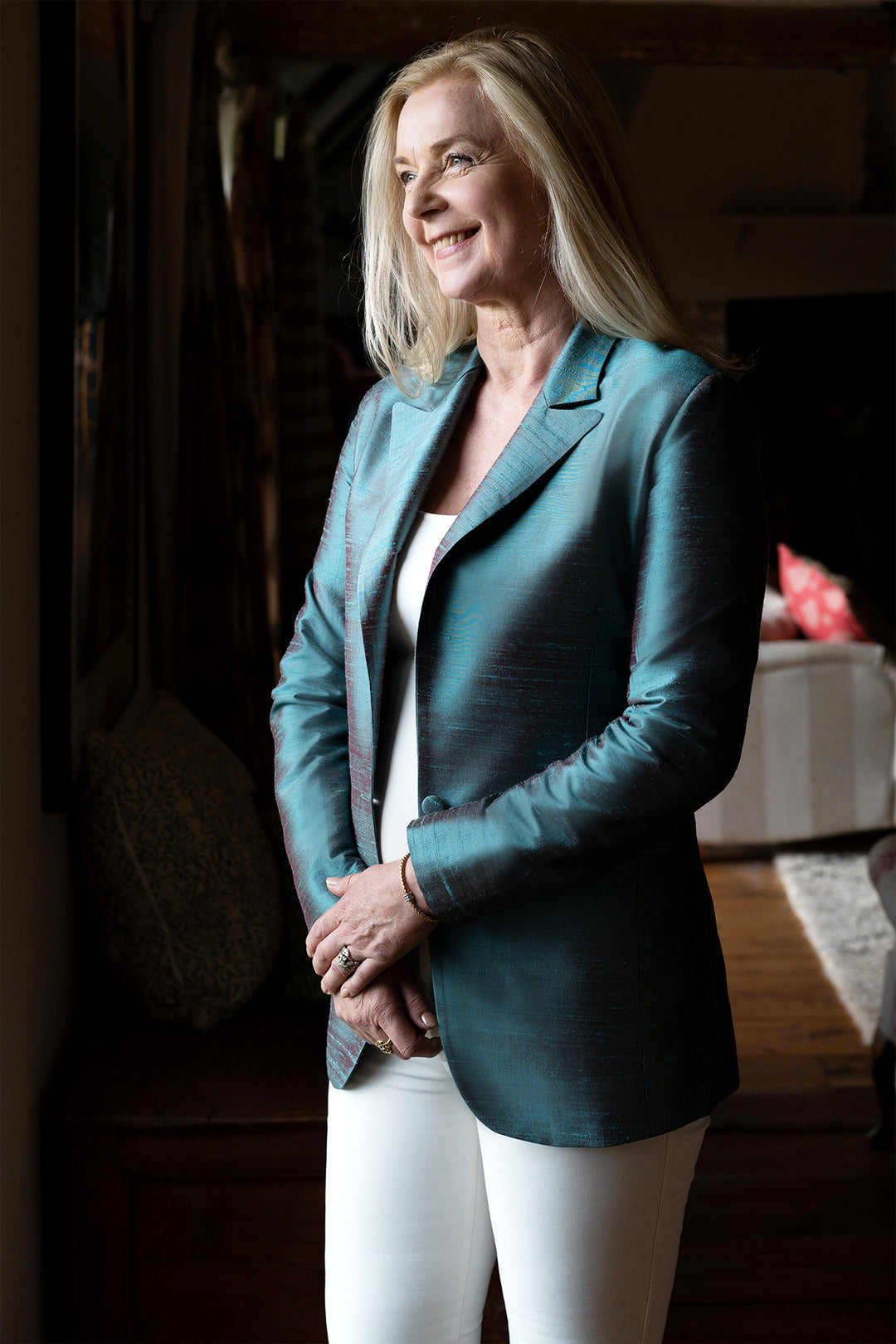 Mature lady wearing silk blue jacket with jeans.