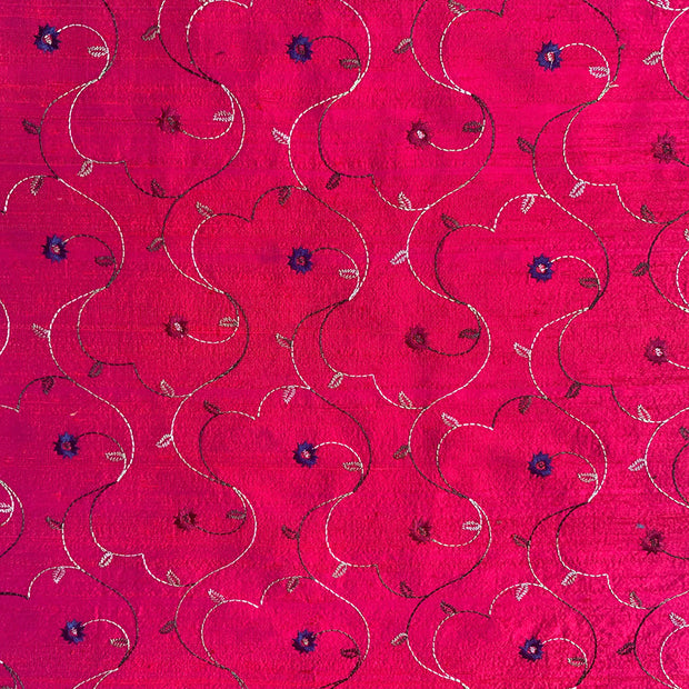 red fabric with embroidered flowers