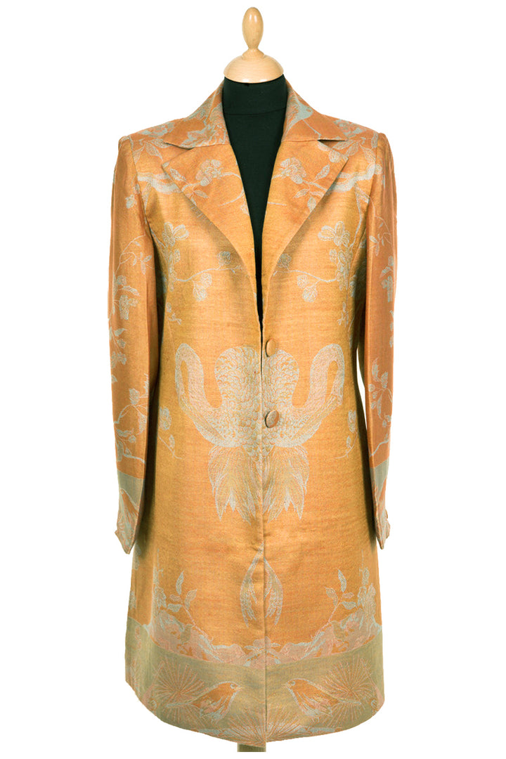 Knee length coat made from cashmere in orange colour with flowers and birds pattern. Women's coat for weddings.