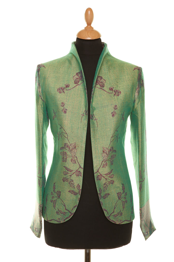 Smart short women's silk jacket in green with floral pattern.