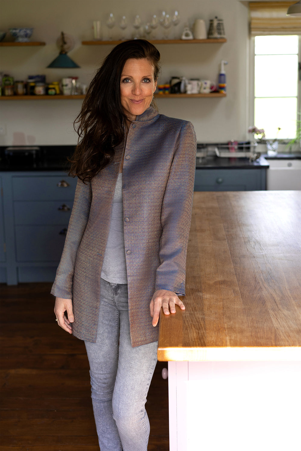 High collar jacket. Long line jacket that goes with trousers.