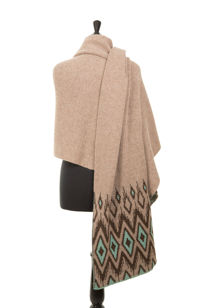 Alpaca scarf with blue and brown diamond pattern.