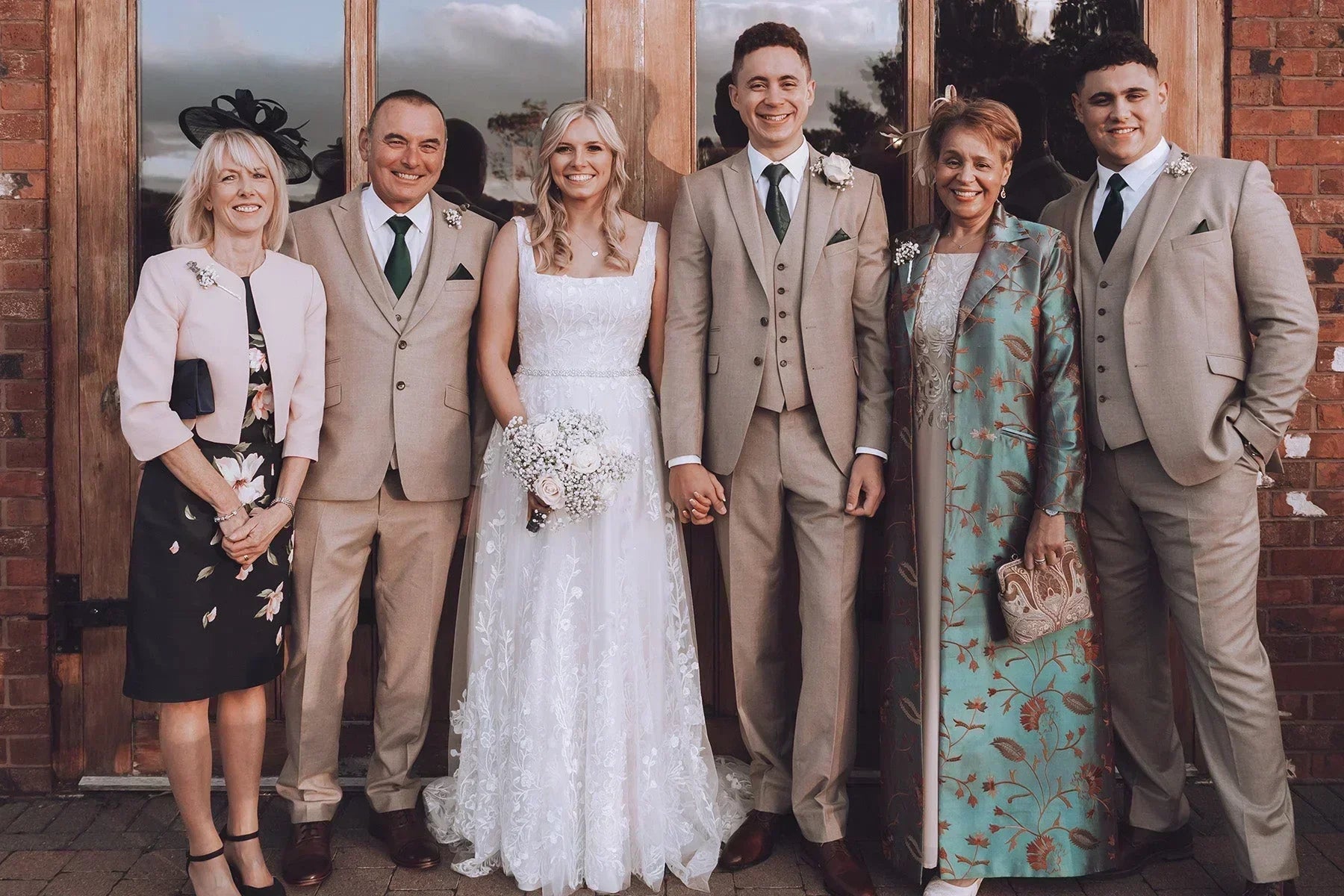 Mother of the Bride wearing a Shibumi embroidered silk coat and dress alongside the bride and family at an autumn wedding.