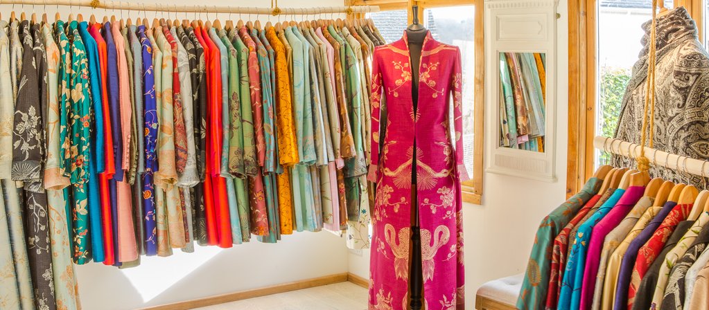 Shibumi showroom displaying colourful silk jackets, coats and occasionwear for weddings and special occasions.
