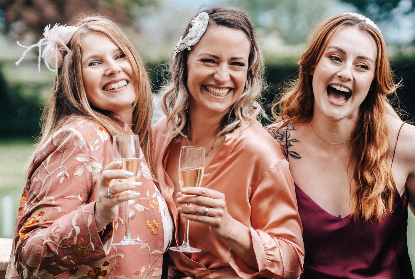 Women at a garden party wearing silk jackets and dresses from Shibumi