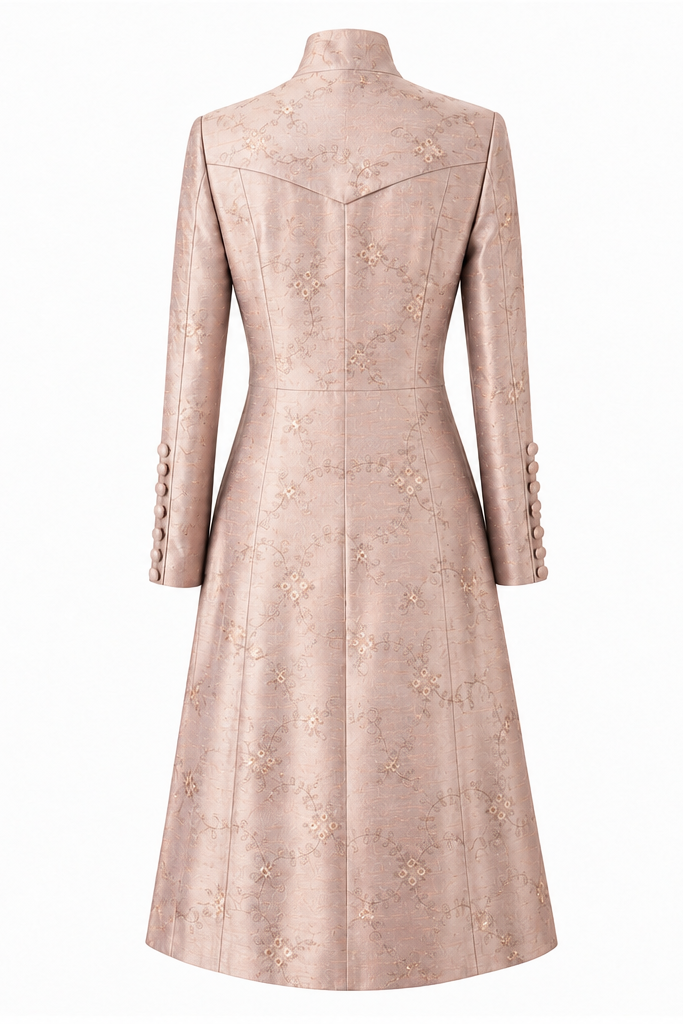 A long-sleeved, high-neck midi coat shown from both front and back views. The coat is a light blush pink with a subtle, tonal floral jacquard pattern and decorative buttons on the front and cuffs.