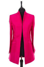 Womens longline jacket with a soft curved collar in a hot pink plain raw silk