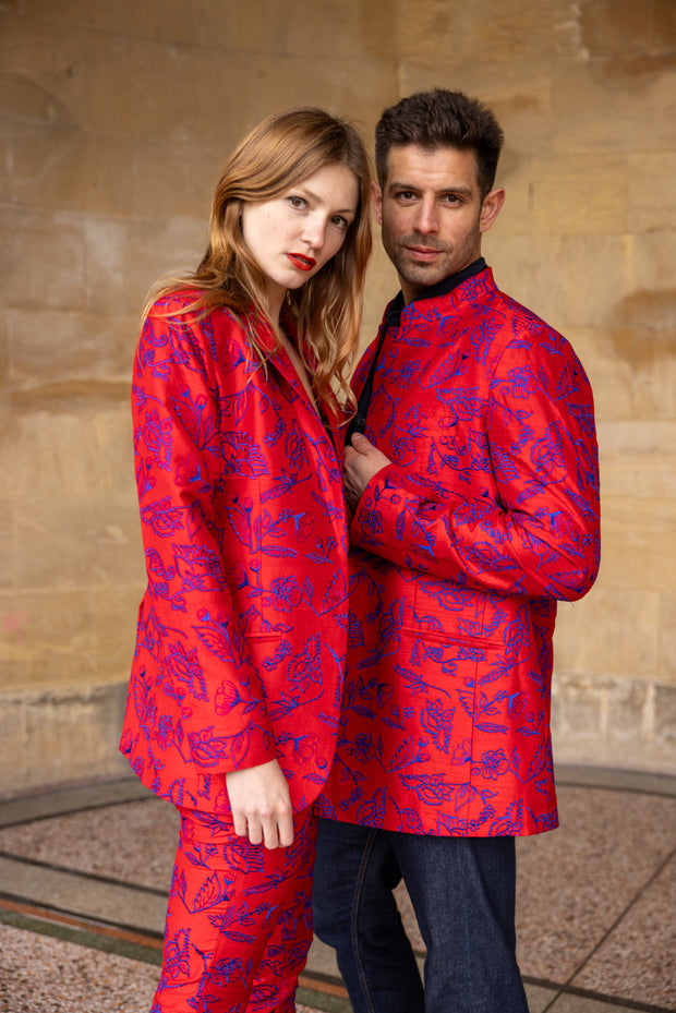 couple wearing matching red silk jackets with embroidered flowers 