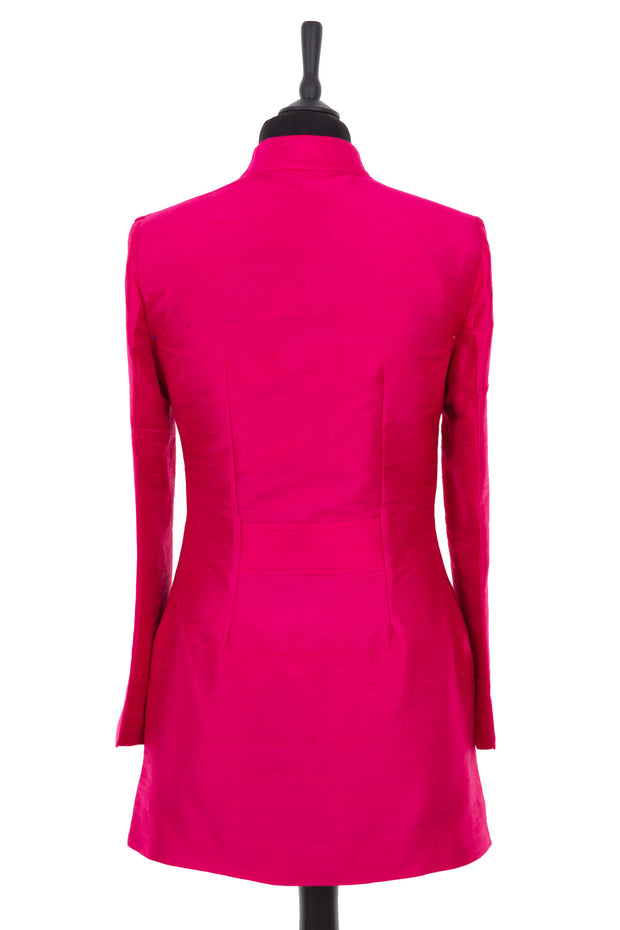 Womens longline jacket with a soft curved collar and half belt in a hot pink plain raw silk
