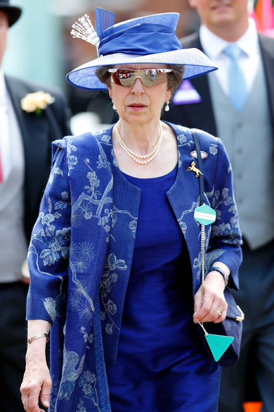 Princess Ann at the Royal Ascot wearing a short blue Shibumi jacket with a shawl in navy. 