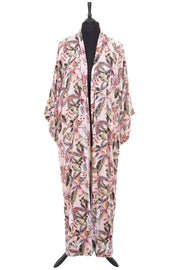 A luxurious pale pink silk velvet dressing gown designed with a beautiful striking botanical pattern embodying many different colours