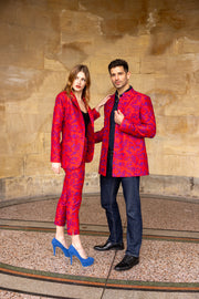 man and women wearing matching silk red jackets for wedding guest
