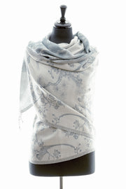 Cashmere silk blend shawl in a pale grey cashmere fabric with a blue undertone, a floral pattern in a darker grey