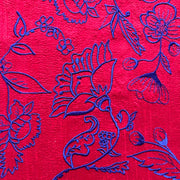bright red vibrant fabric with blue flowers
