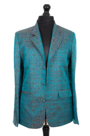 Mens silk blazer jacket with a revere collar in a dark teal jacquard embroidered raw silk with pink, blue, gold and black detail