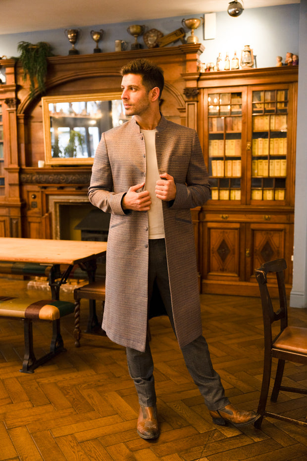 handsome man wearing trousers and stunning knee length coat in blue