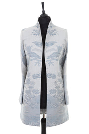 Womens longline frock jacket with a soft curved collar in a pale grey cashmere fabric with a blue undertone, a floral pattern in a darker grey
