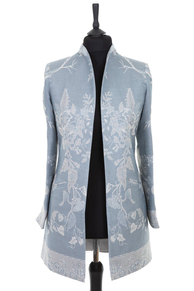 Womens longline jacket with a soft curved collar in a blue toned grey cashmere fabric with a pale grey floral pattern