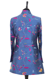 Womens longline jacket, with a soft curved collar in a blue embroidered raw silk with a lighter blue, pink and yellow pattern