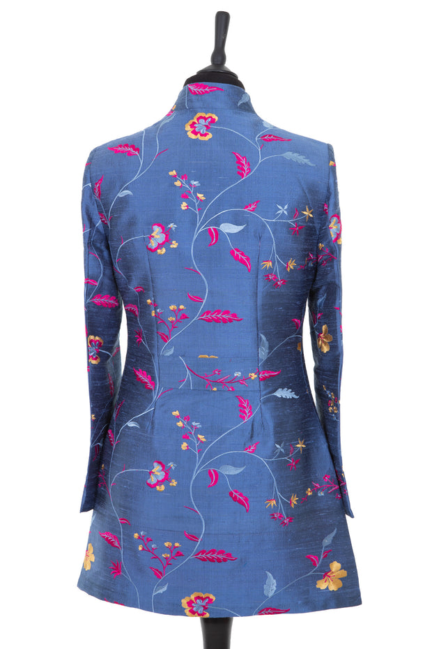 Womens longline jacket, with a soft curved collar in a blue embroidered raw silk with a lighter blue, pink and yellow pattern