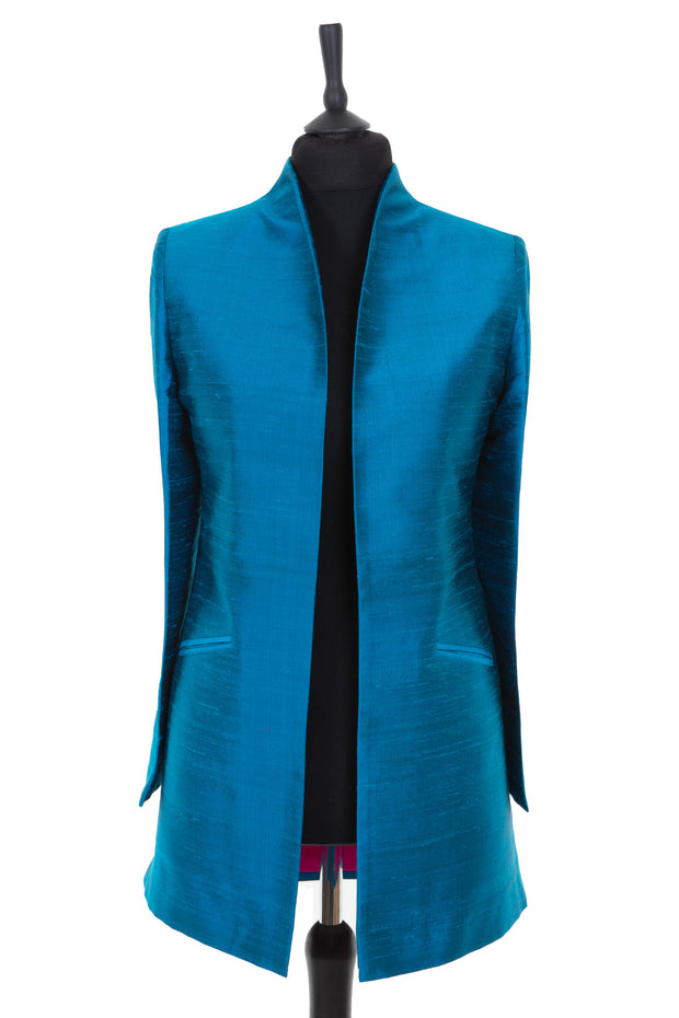 Womens longline jacket with a soft curved collar in a bright kingfisher, teal blue plain raw silk