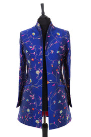 Womens longline jacket with a curved collar in a cobalt blue embroidered silk with vibrant coloured embroidery