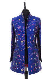 Womens longline jacket with a curved collar in a cobalt blue embroidered silk with vibrant coloured embroidery