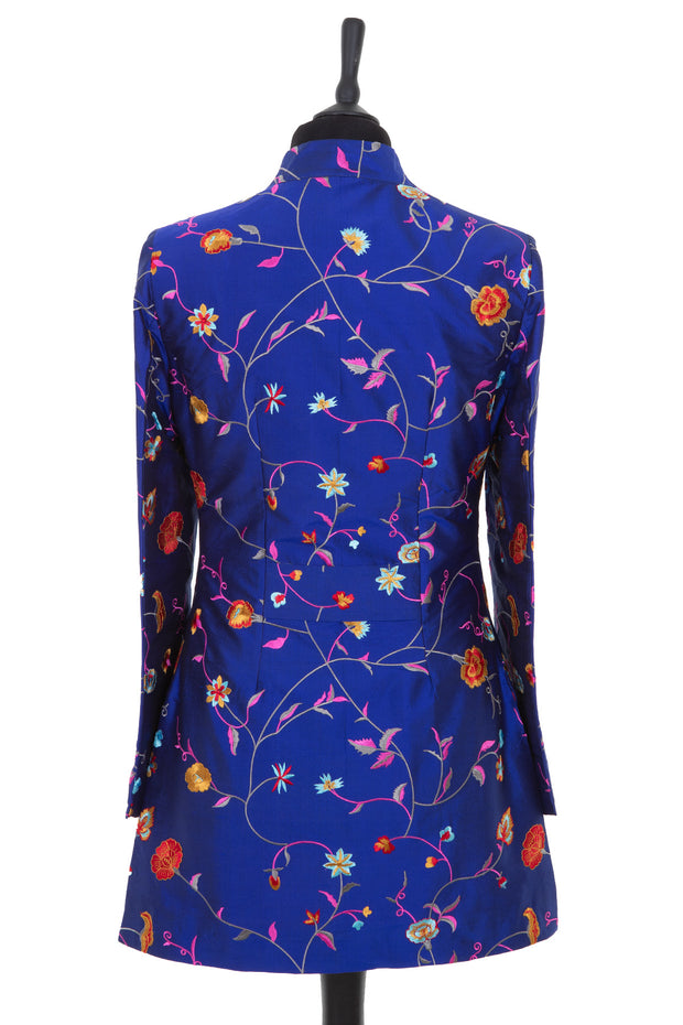 Womens longline jacket with a curved collar in a cobalt blue embroidered silk with vibrant coloured embroidery