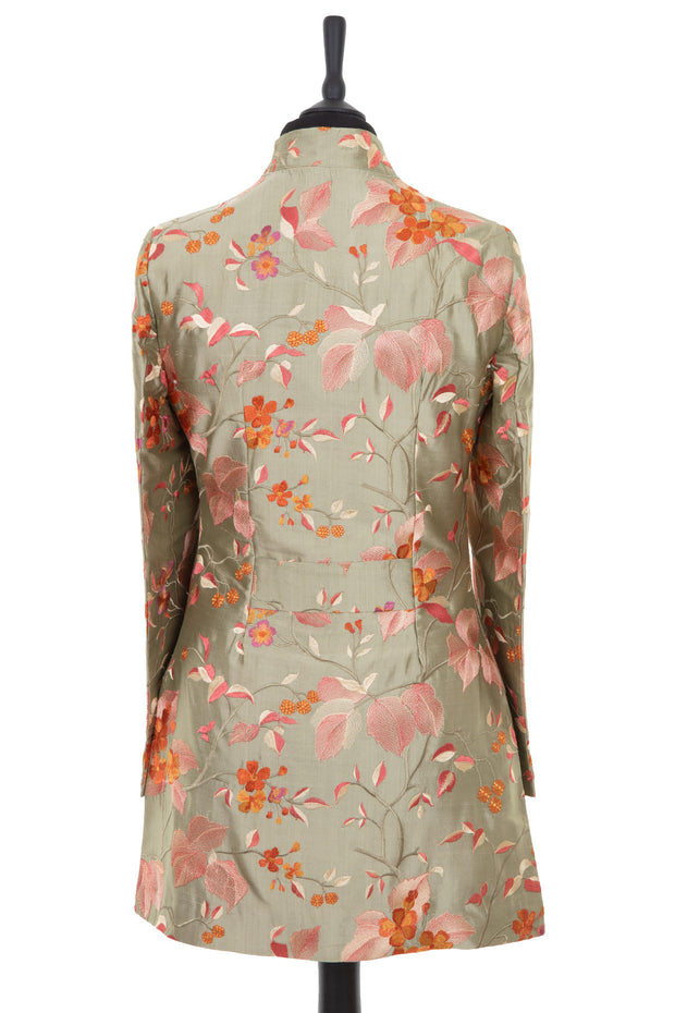 Womens longline jacket with a soft curved collar and slit pockets in a pearlesque soft pale green embroidered silk with soft pink, coral and burnt orange embroidery